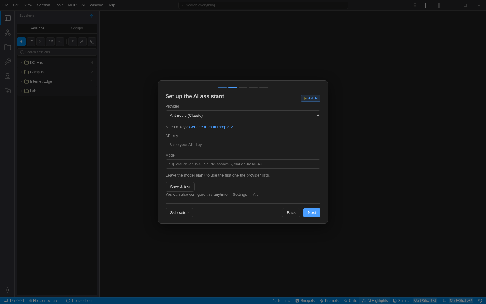 The NetStacks first-run wizard on the AI setup step with a provider dropdown showing Anthropic (Claude), an API key field and a model field
